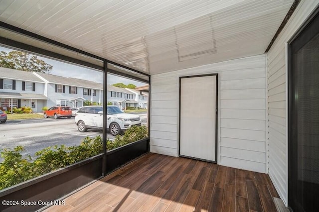 unfurnished sunroom featuring a healthy amount of sunlight and vaulted ceiling