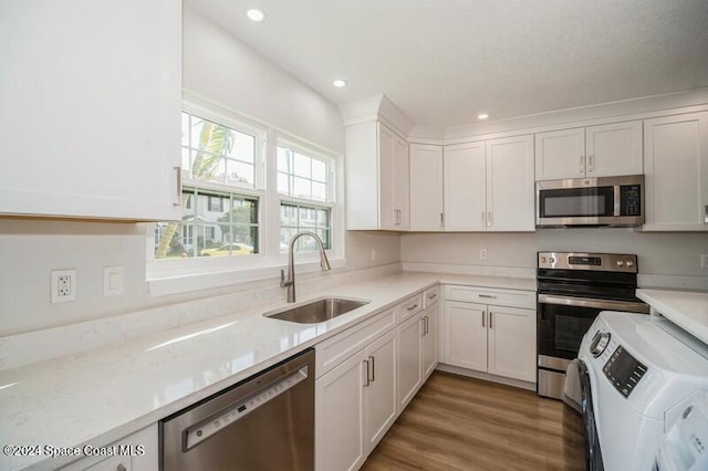 kitchen featuring white cabinetry, sink, and stainless steel appliances