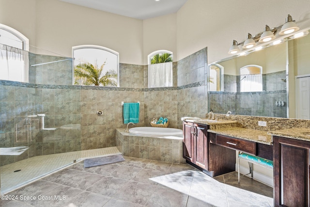 bathroom featuring tile patterned floors, vanity, and independent shower and bath