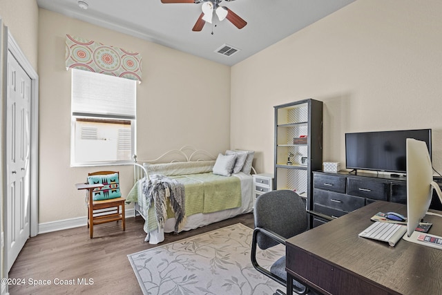 bedroom with ceiling fan, a closet, and light wood-type flooring