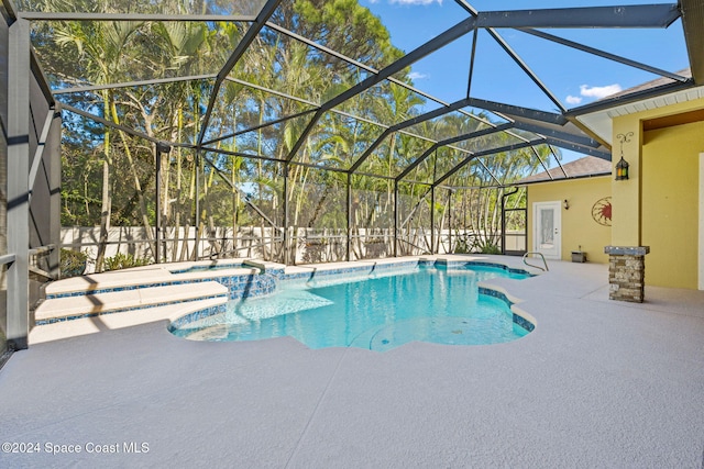 view of swimming pool featuring a lanai, a patio, and an in ground hot tub