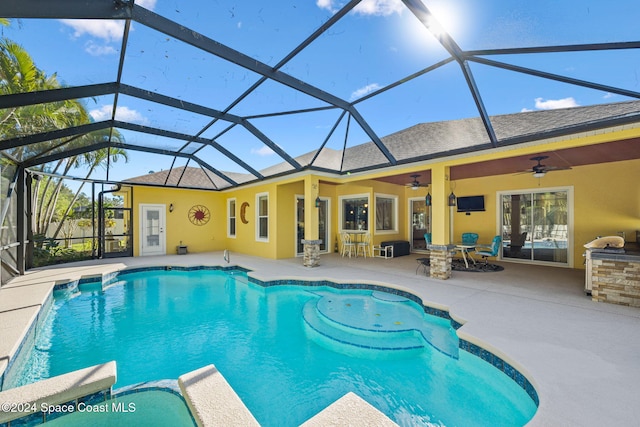 view of pool with a patio area, ceiling fan, and a lanai