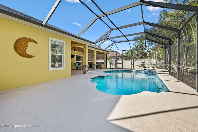 view of swimming pool with an in ground hot tub, a patio, and glass enclosure