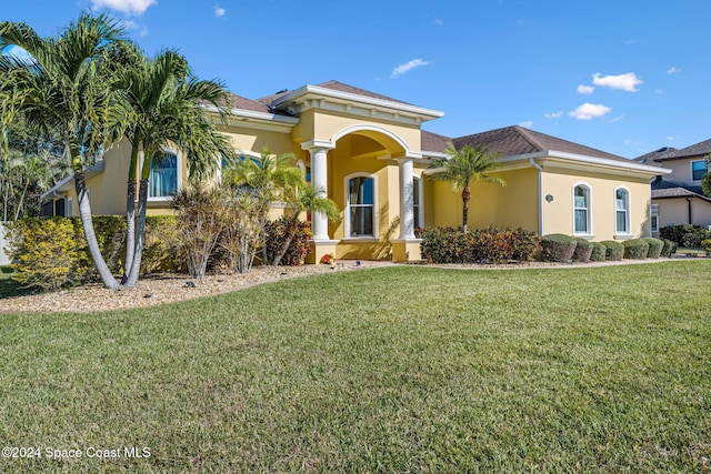 mediterranean / spanish home featuring a front yard