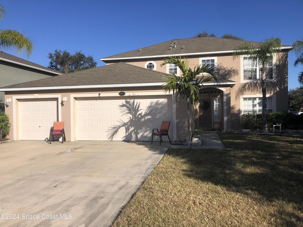 view of front property with a garage and a front lawn