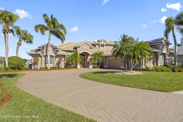 view of front of home with a front yard and a garage