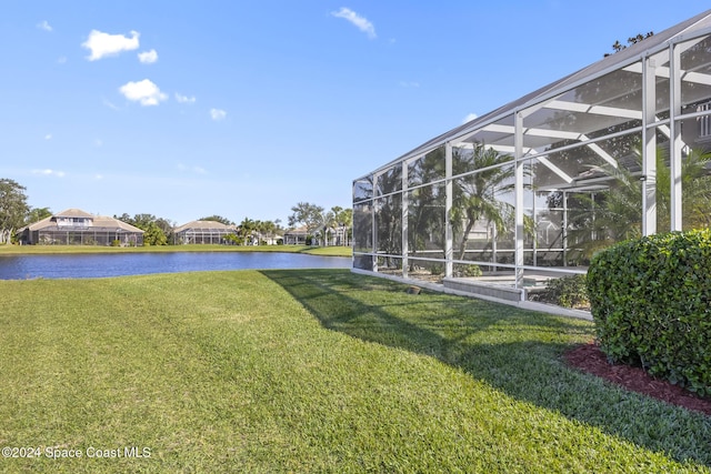 view of yard with glass enclosure and a water view