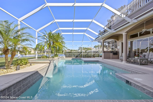 view of swimming pool with a lanai, area for grilling, ceiling fan, and a patio area