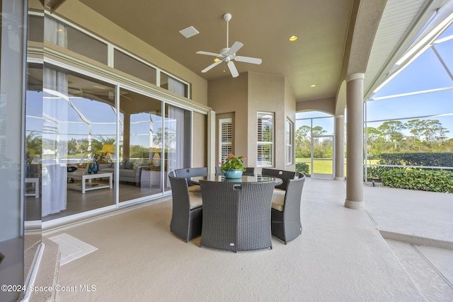 view of patio / terrace with ceiling fan and glass enclosure