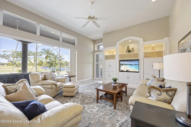 tiled living room featuring ceiling fan