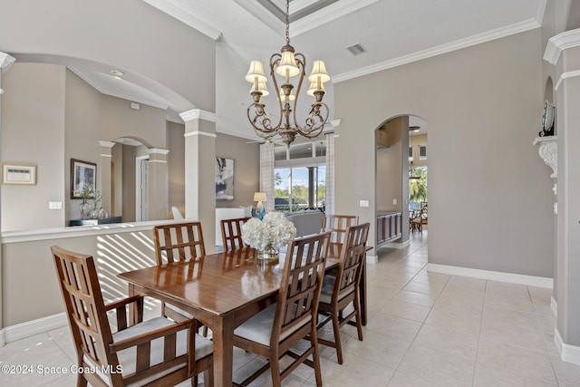 dining room with light tile patterned floors, decorative columns, ornamental molding, and a notable chandelier