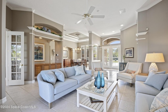 tiled living room featuring french doors, ceiling fan with notable chandelier, and crown molding