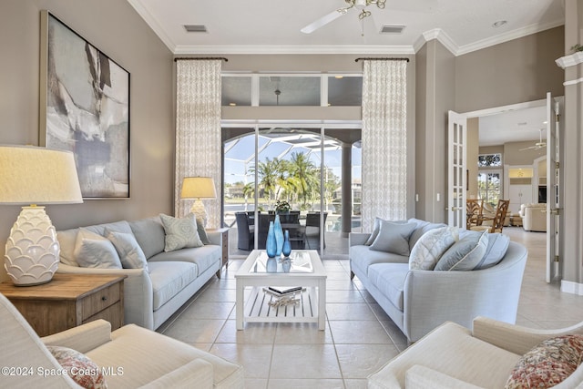 living room featuring ceiling fan, light tile patterned flooring, and ornamental molding