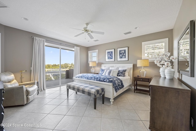 bedroom featuring access to exterior, light tile patterned floors, a textured ceiling, and ceiling fan