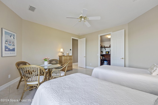 tiled bedroom featuring ceiling fan