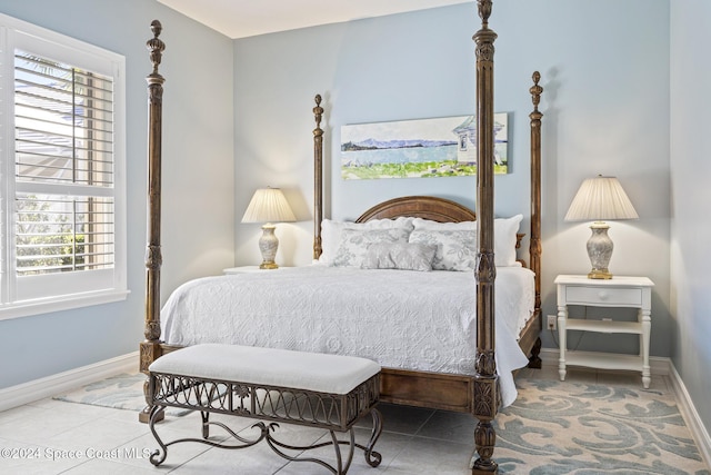 tiled bedroom featuring multiple windows