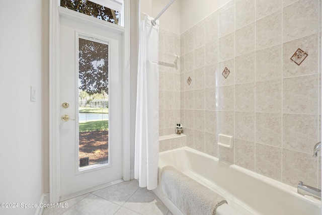 bathroom featuring tile patterned floors and shower / bath combo with shower curtain