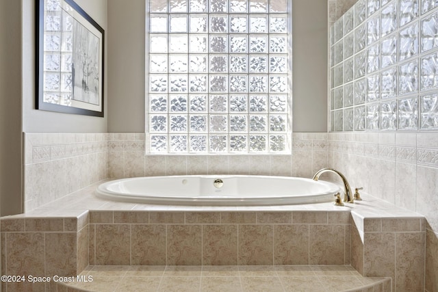 bathroom with tiled tub