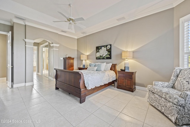 tiled bedroom with ornate columns, ceiling fan, and crown molding