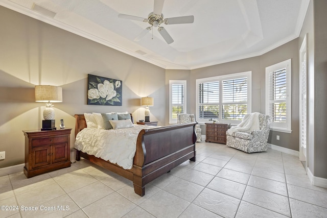 bedroom with ceiling fan, light tile patterned flooring, ornamental molding, and a tray ceiling