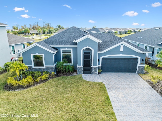 view of front of property with a front lawn and a garage