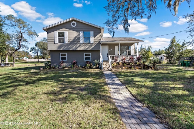 tri-level home with a front lawn and a porch