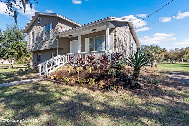 split level home with a porch and a front yard