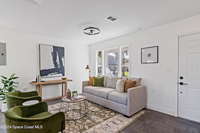 living room with dark wood-type flooring and electric panel