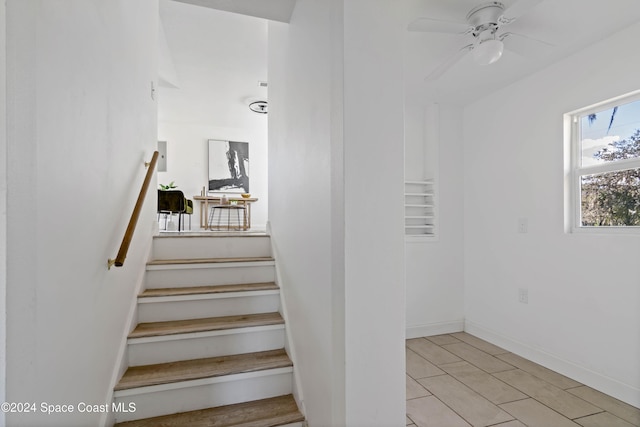 stairway with ceiling fan