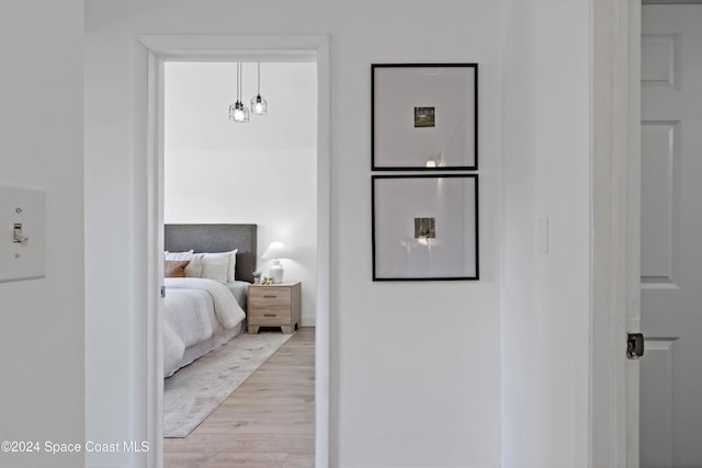 bedroom featuring light hardwood / wood-style floors and a chandelier