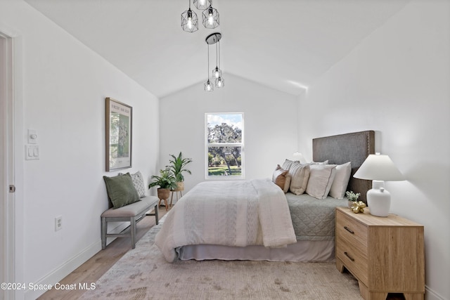 bedroom with light hardwood / wood-style flooring and vaulted ceiling