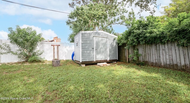 view of outbuilding with a yard