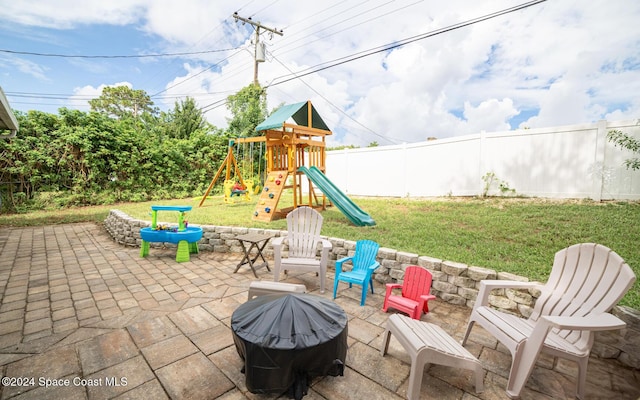 view of patio / terrace with a playground and area for grilling