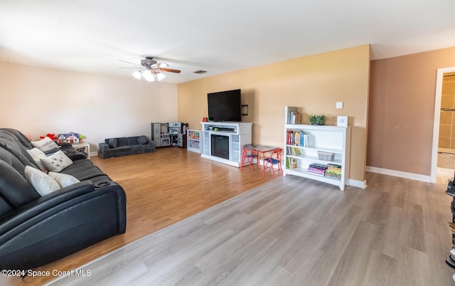 living room featuring ceiling fan and light hardwood / wood-style flooring