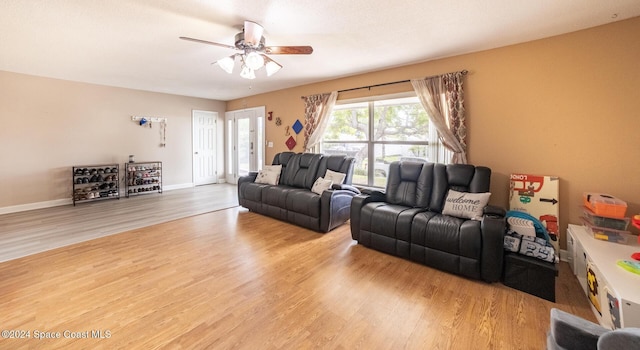 living room featuring hardwood / wood-style flooring and ceiling fan