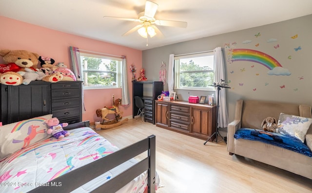 bedroom with light hardwood / wood-style floors, multiple windows, and ceiling fan