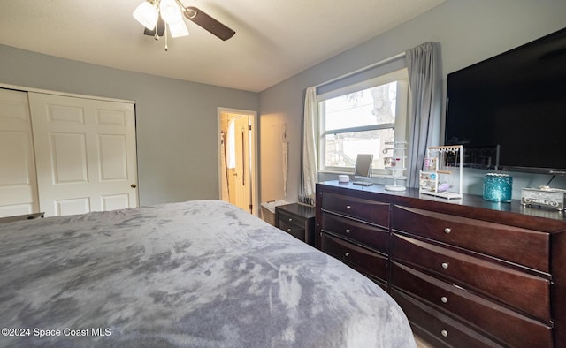 bedroom featuring ceiling fan and a closet