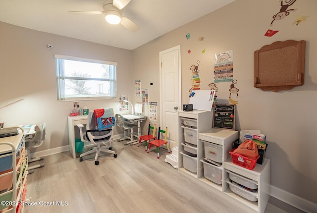 office space with ceiling fan and light hardwood / wood-style flooring