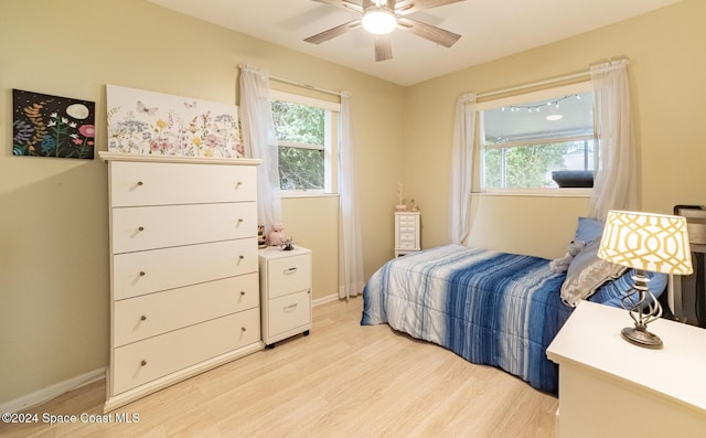 bedroom with ceiling fan and light hardwood / wood-style flooring