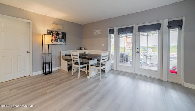 dining space featuring french doors and light hardwood / wood-style flooring