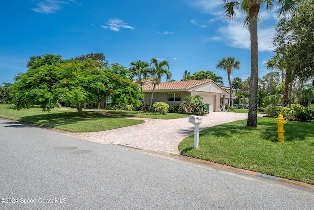 view of front of house featuring a front yard and a garage