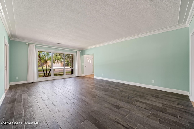 empty room with a textured ceiling, dark hardwood / wood-style floors, and ornamental molding