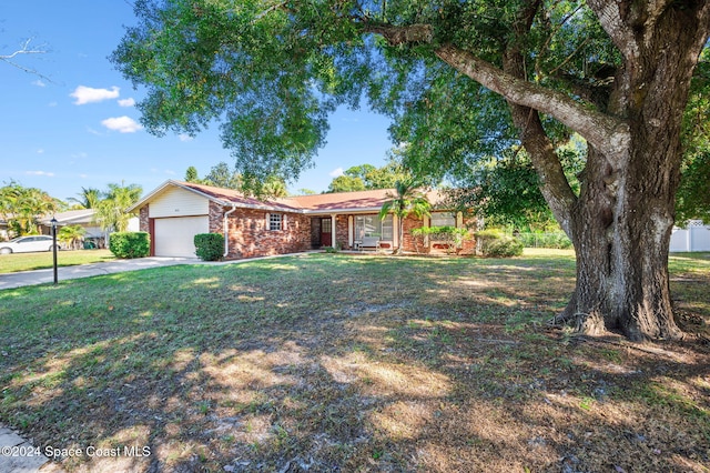 single story home featuring a garage and a front lawn