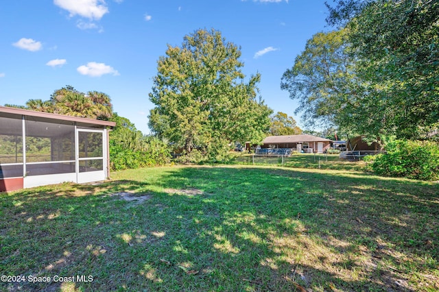 view of yard with a sunroom