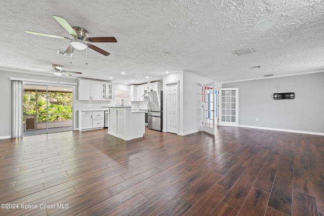 unfurnished living room with ceiling fan, wood-type flooring, and a textured ceiling