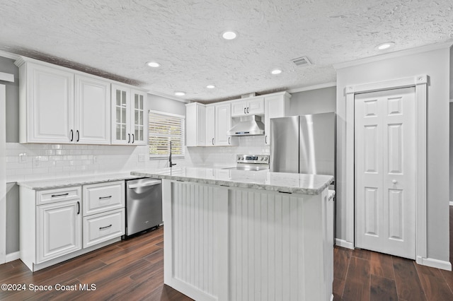 kitchen with white cabinets, dark hardwood / wood-style floors, and a kitchen island