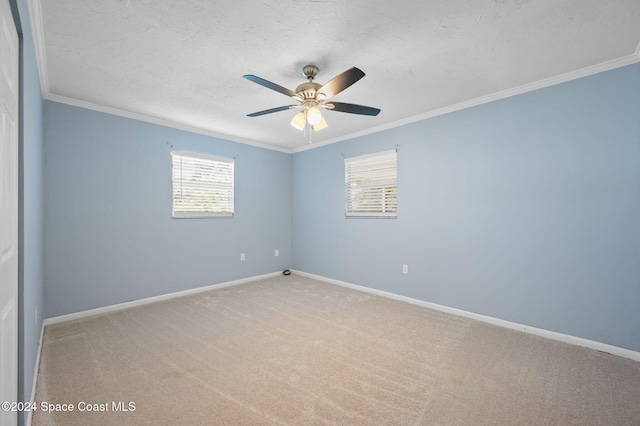 carpeted empty room with ceiling fan, a textured ceiling, and ornamental molding