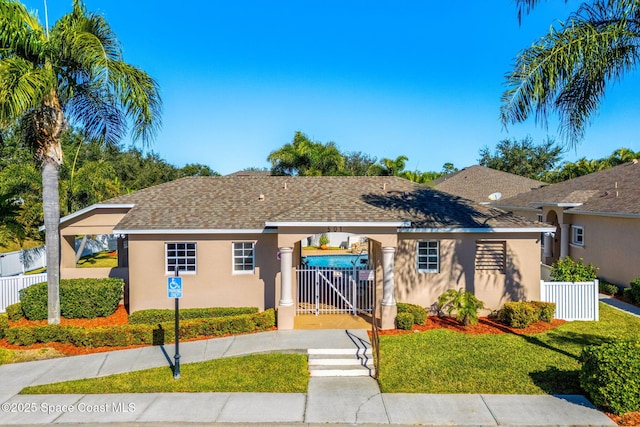 bungalow-style home with a front yard