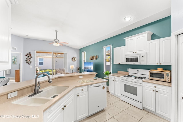 kitchen featuring white appliances, sink, a wealth of natural light, and white cabinetry