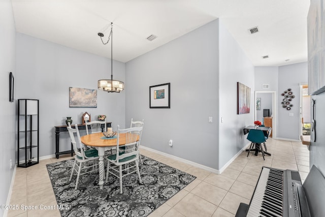 tiled dining area with an inviting chandelier